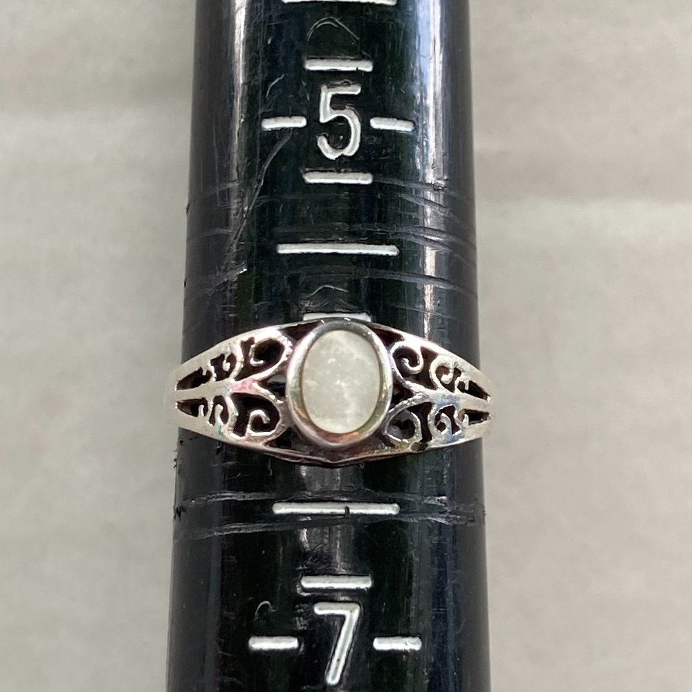 Delicate looking mother of pearl gem in sterling silver setting.